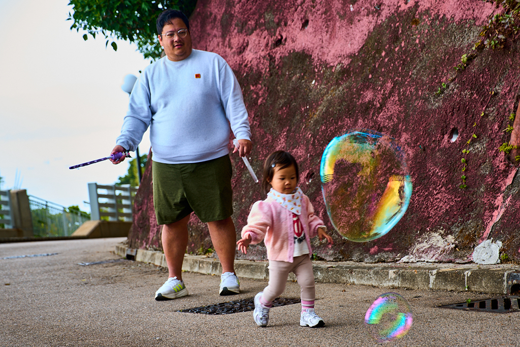 Chasing a giant soap bubble by Maurice Ping Leung