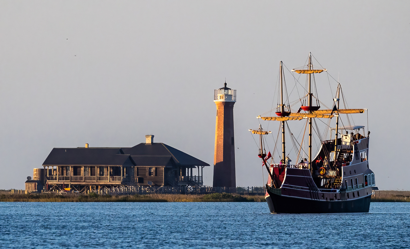 Port Aransas Texas Lighthouse With Passing Pirate Ship by Gary Walter, QPSA